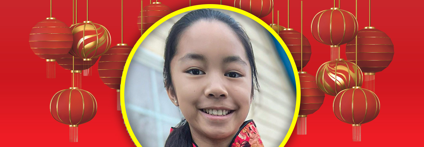 Image of a person smiling and surrounded by red Chinese lanterns