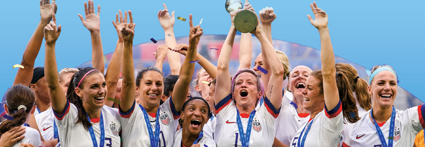 Women&apos;s USA Soccer team celebrating with medals and a trophy