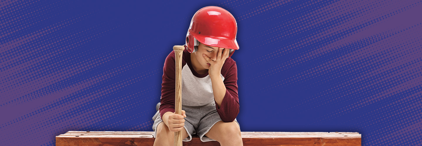 Image of an upset baseball player sitting on the bench