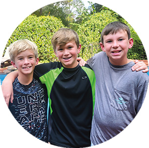 Image of three kids posing for photo together